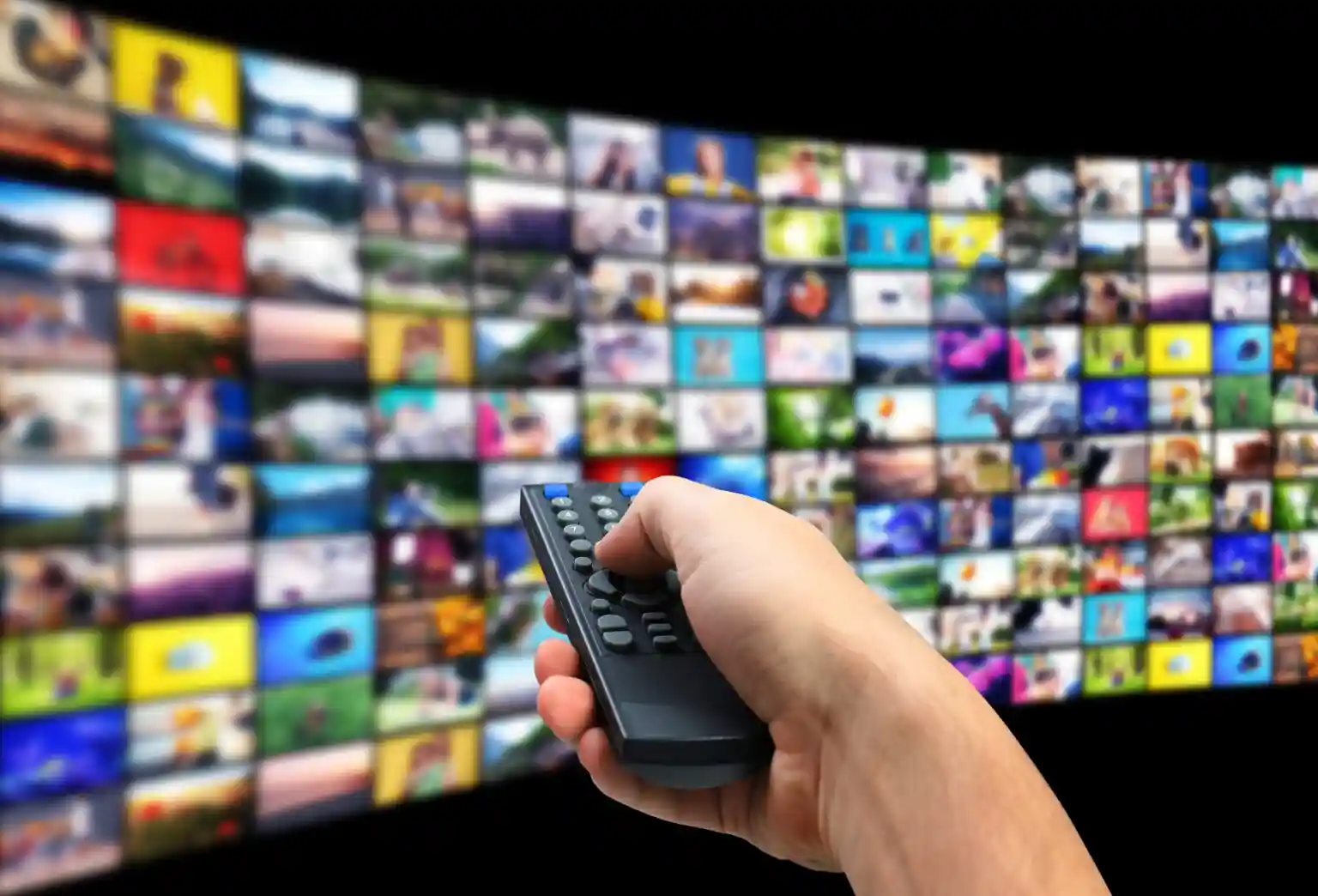 Man using remote control to browse IPTV UK streaming service with thousands of live TV channels, movies, and sports on smart TV